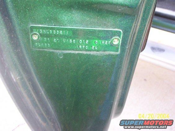 Close-up of a VIN plate on a green vehicle, showing '1970 86'