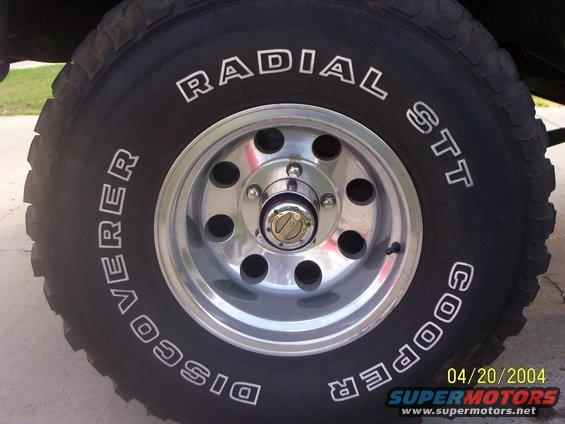 Close-up of Cooper Discoverer Radial STT tire and chrome wheel with date stamp