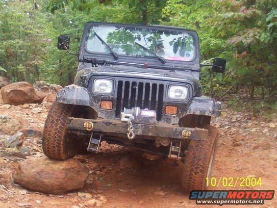 Black Jeep Wrangler TJ on rocky trail, front view. Date stamp 10/02/2004
