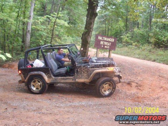 Black 1994 Jeep YJ on dirt road