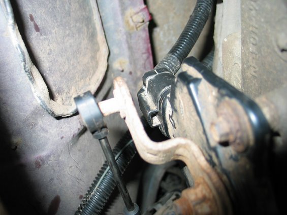 img_2808.jpg Remove the black plug on the drivers side of the tranny. Pull the round linkage end off for the shift linkage. Remove the linkage by pinching the tabs. 