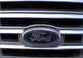 2000 Ford Crown Victoria - Close-up of a Ford emblem on a vehicle's front grille.