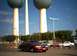 2000 Ford Crown Victoria - A red sedan is parked in a lot with large water towers in the background.