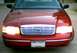 2000 Ford Crown Victoria - Front view of a red 2000 Ford Crown Victoria showing its grille and headlights.