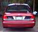 2000 Ford Crown Victoria - The rear of a red sedan is shown, its taillights and license plate area.