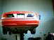 2000 Ford Crown Victoria - Rear view of a red 2000 Ford Crown Victoria being serviced on a lift.