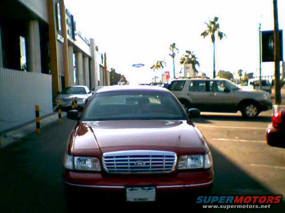 Red 2000 Ford Crown Victoria front view parked on street