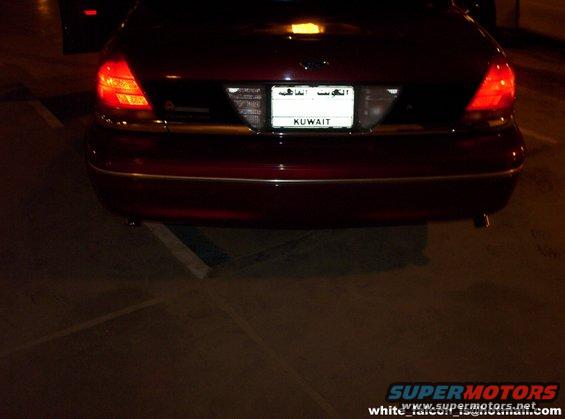 Red 2000 Ford Crown Victoria rear view with Kuwait license plate