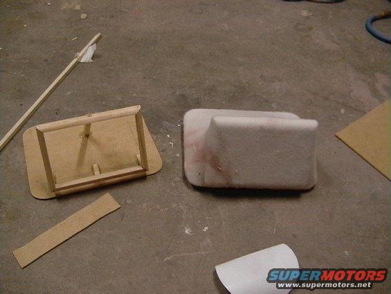 Car interior part and a wooden frame on a concrete floor