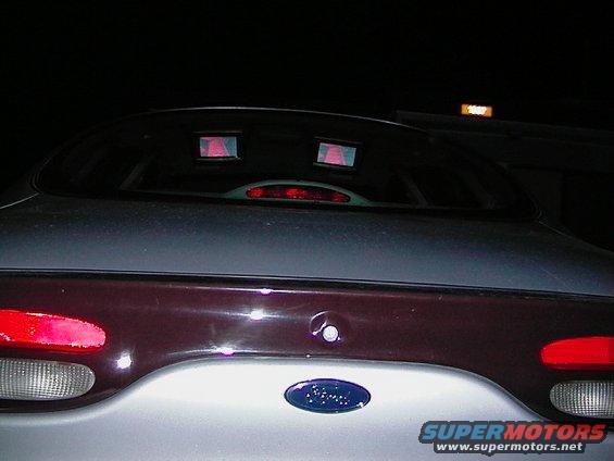 1999 Ford Taurus rear with two red lights on the back window and a Ford logo on the trunk