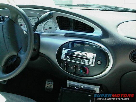1999 Ford Taurus interior showing dashboard, steering wheel, and center console with aftermarket stereo