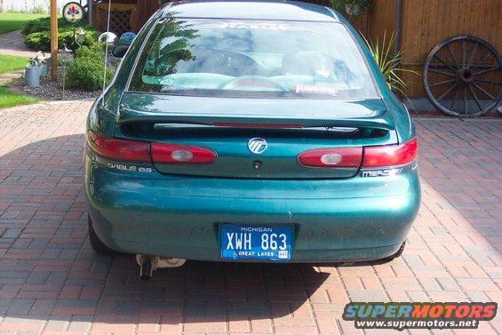 Green 1996 Mercury Sable sedan, rear view, with a spoiler and Michigan license plate XWH 863