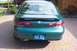 1996 Mercury Sable - The rear of a green 1996 Mercury Sable sedan is visible, parked on a brick driveway.