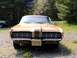 1970 Mercury Cougar - A gold 1970 Mercury Cougar is parked outdoors, with another vehicle visible in the background.