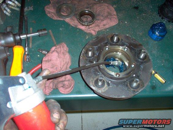 62-grease.jpg Fill the area between the bearing races with grease.  This prevents the bearings from throwing their grease out, and reduces the amount of air inside the hub, which reduces its tendency to suck in water during fording.