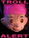 1986 Ford Bronco - This image features a troll doll head with bright pink hair and red, glowing eyes, accompanied by text indicating a 'Troll Alert'.