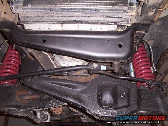 Undercarriage view of red coil springs and suspension parts
