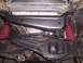 1988 Ford Ranger - Undercarriage view shows red coil springs and various suspension components, with a radiator visible above.