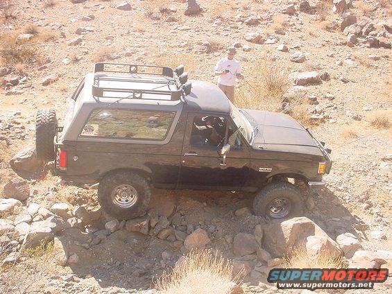 Black 1988 Ford Bronco navigating rocky terrain