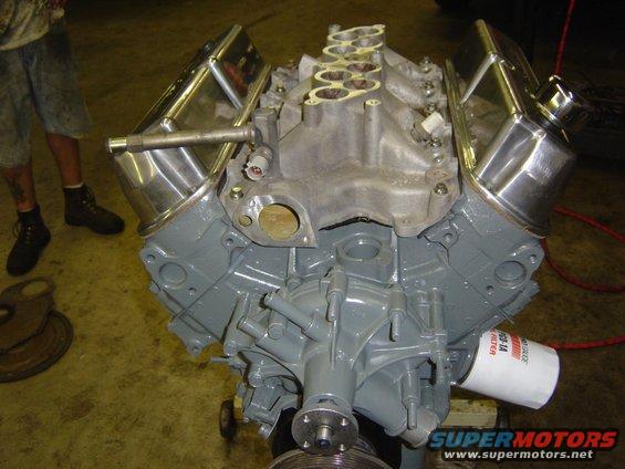 V8 engine with chrome valve covers and intake manifold, oil filter visible