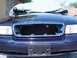 1999 Ford Crown Victoria - Front view of a Ford Crown Victoria with the grille removed, hood covered.