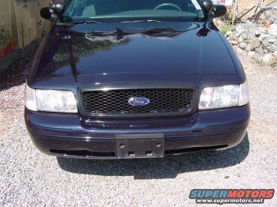Dark blue 1999 Ford Crown Victoria front grille with honeycomb pattern and Ford badge