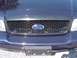1999 Ford Crown Victoria - Close-up of a Ford Crown Victoria's front grille and bumper assembly.