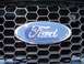 1999 Ford Crown Victoria - The Ford emblem is centered on a black grille with a hexagonal pattern.