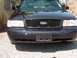 1999 Ford Crown Victoria - Front view of a Ford Crown Victoria, showing the grille and headlights.