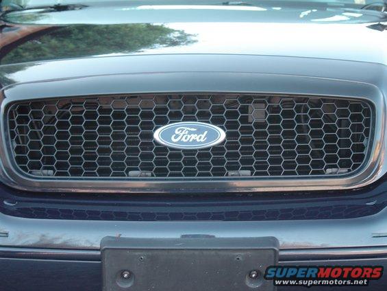 Dark blue Ford Crown Victoria grille with honeycomb pattern and Ford oval badge. Front view