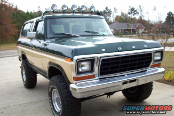 Green and tan 1978 Ford Bronco with roof lights, 3q-front view