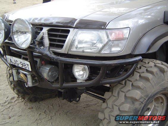 Silver SUV front with winch and off-road tires