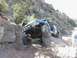 1988 Ford Bronco - A heavily modified off-road vehicle navigates a challenging rocky terrain.