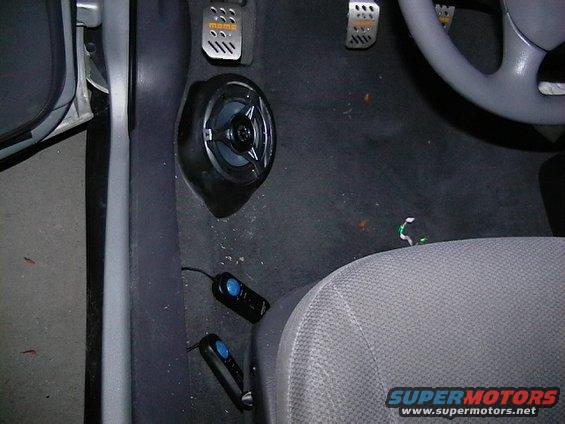 Car interior showing floor speaker, MOMO pedals, and part of the steering wheel