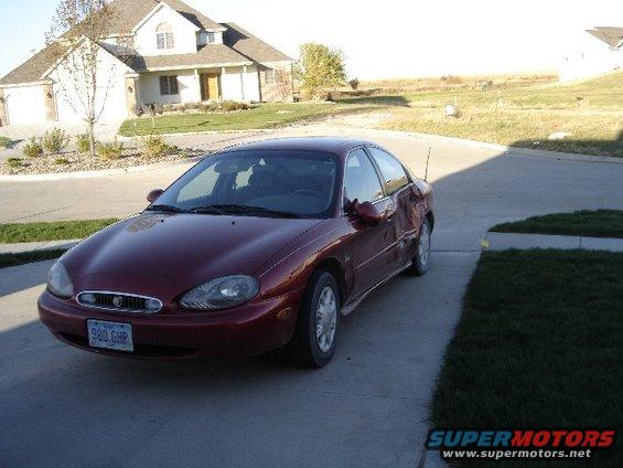 1998 Mercury Sable sedan, maroon, parked on concrete driveway. License plate reads 980 GHP