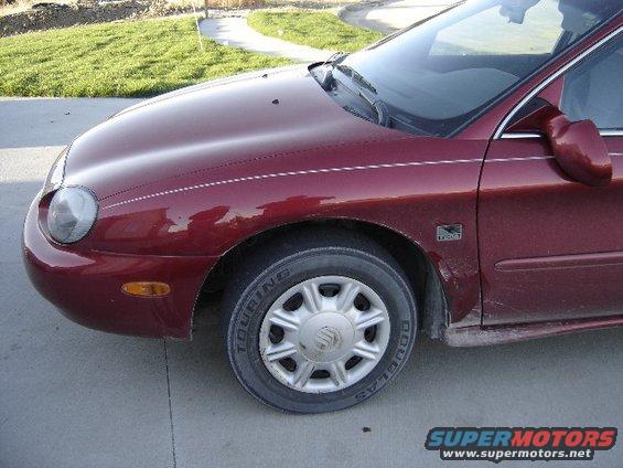 maroon sedan front fender and wheel