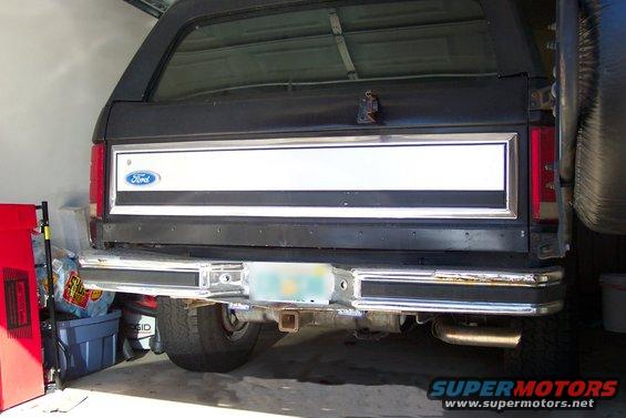 Rear of a black 1986 Ford Bronco with a white stripe on the tailgate