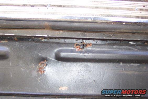 Close-up of rust on a vehicle's tailgate