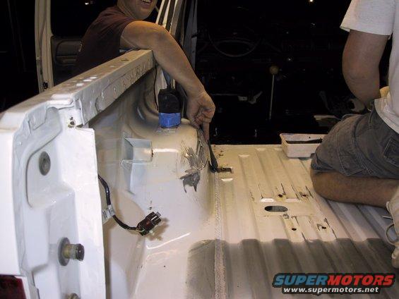 Interior of vehicle bed with white coating and visible wiring