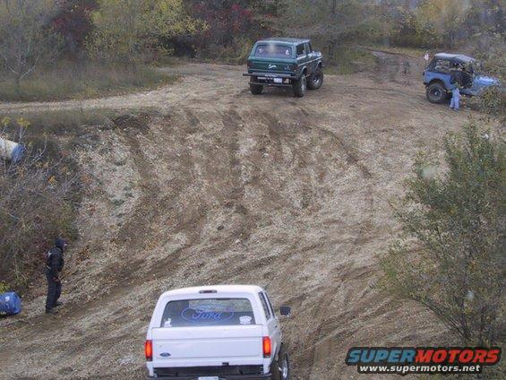 White 1993 Ford Bronco rear view on dirt road