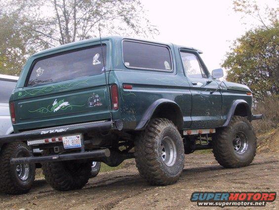 Lifted green Ford Bronco with custom pinstriping and a bumper sticker that says "Don't Push!"