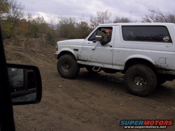 White 1993 Ford Bronco on a muddy trail