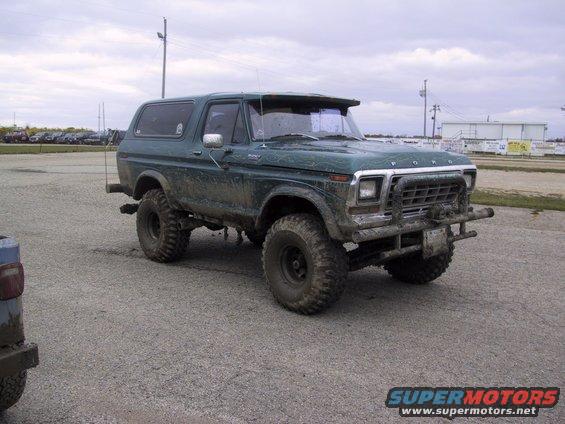 Green lifted Ford Bronco with aftermarket grille guard