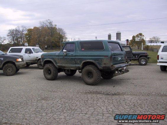 Green Ford Bronco parked with other trucks and SUVs