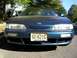 1995 Nissan 240SX - The front of a teal Nissan 240SX is parked on a residential street.
