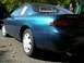 1995 Nissan 240SX - A blue 1995 Nissan 240SX coupe is parked outdoors, displaying a 'For Sale' sign in its rear window.
