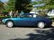 1995 Nissan 240SX - Side profile of a blue 1995 Nissan 240SX coupe on a residential street.