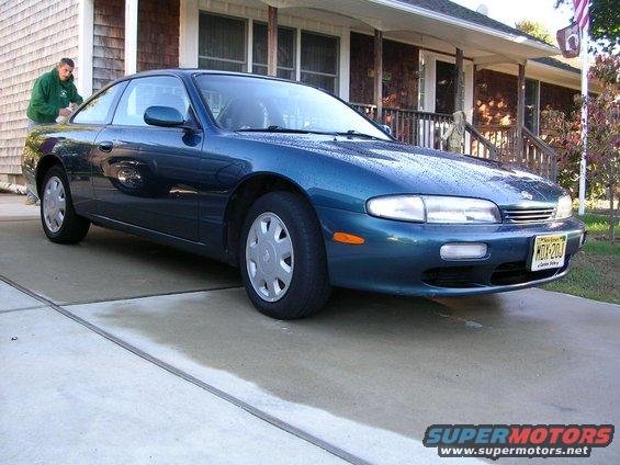 Blue 1995 Nissan 240SX coupe parked on a driveway, front 3/4 view