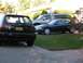 1995 Nissan 240SX - Three vehicles are parked in a residential driveway on a sunny day.
