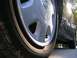 1995 Nissan 240SX - Close-up of the wheel and side of a 1995 Nissan 240SX, showing the Nissan badge on the hubcap.